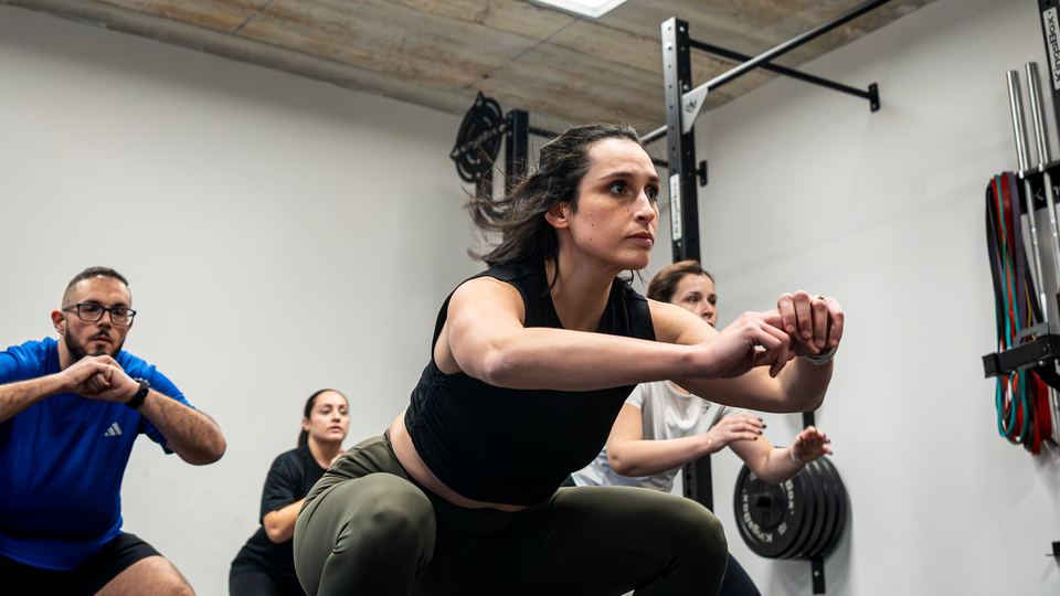 Members squatting through a BURN class