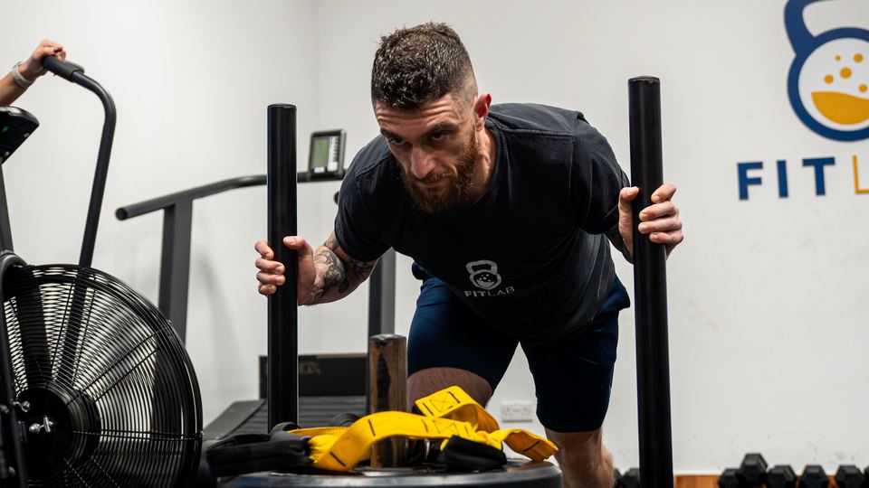 Sled push on the FitLab turf during a HYPE class